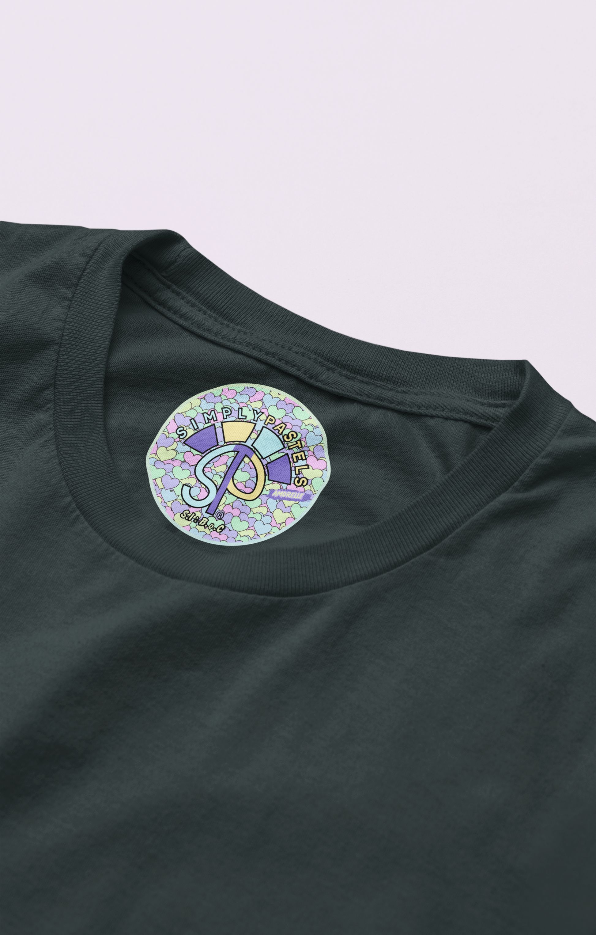 Label view of the black Amorelle organic cotton t-shirt with a pastel graphic design, from Simply Pastels, a UK-based premium ethical clothing brand.