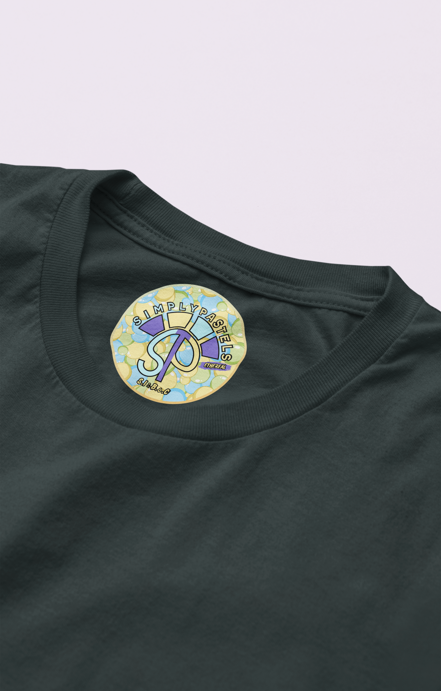 Label view of the black Ethereal t-shirt with a pastel graphic design from Simply Pastels, a UK-based premium ethical clothing brand.