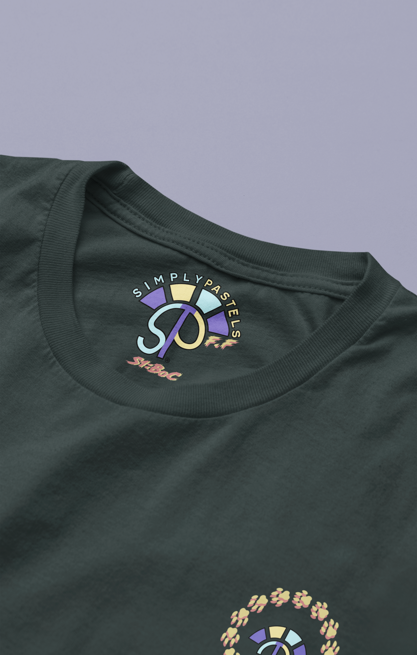 Label view of the black Firm Fortitude organic cotton t-shirt with a pastel graphic design, from Simply Pastels, a UK-based premium ethical clothing brand.