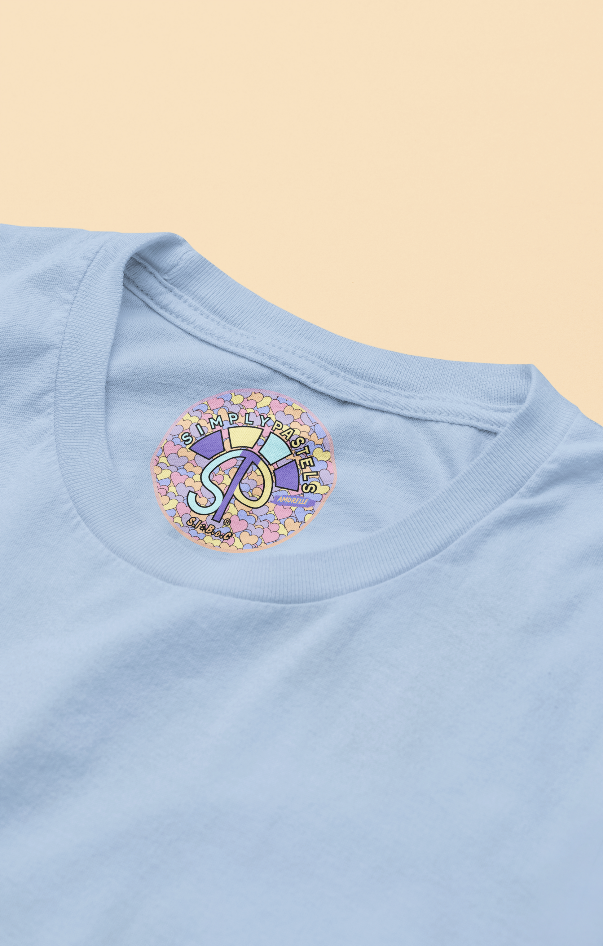 Label view of the blue soul Amorelle  organic cotton t-shirt with a pastel graphic design, from Simply Pastels, a UK-based premium ethical clothing brand.