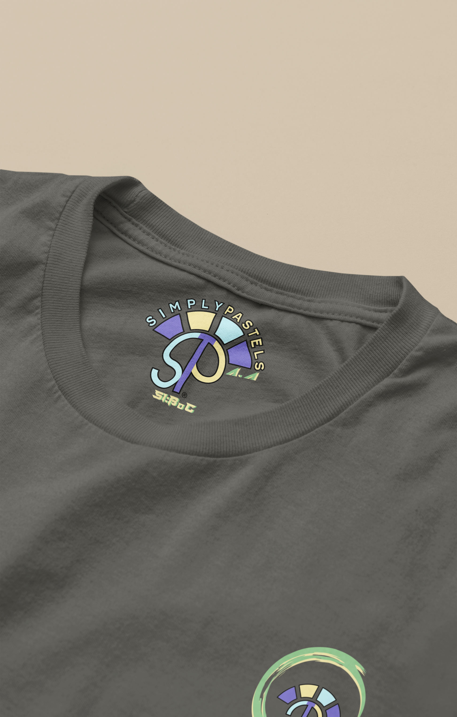 Label view of the khaki Avid Aspiration organic cotton t-shirt with a pastel graphic design, from Simply Pastels, a UK-based premium ethical clothing brand.