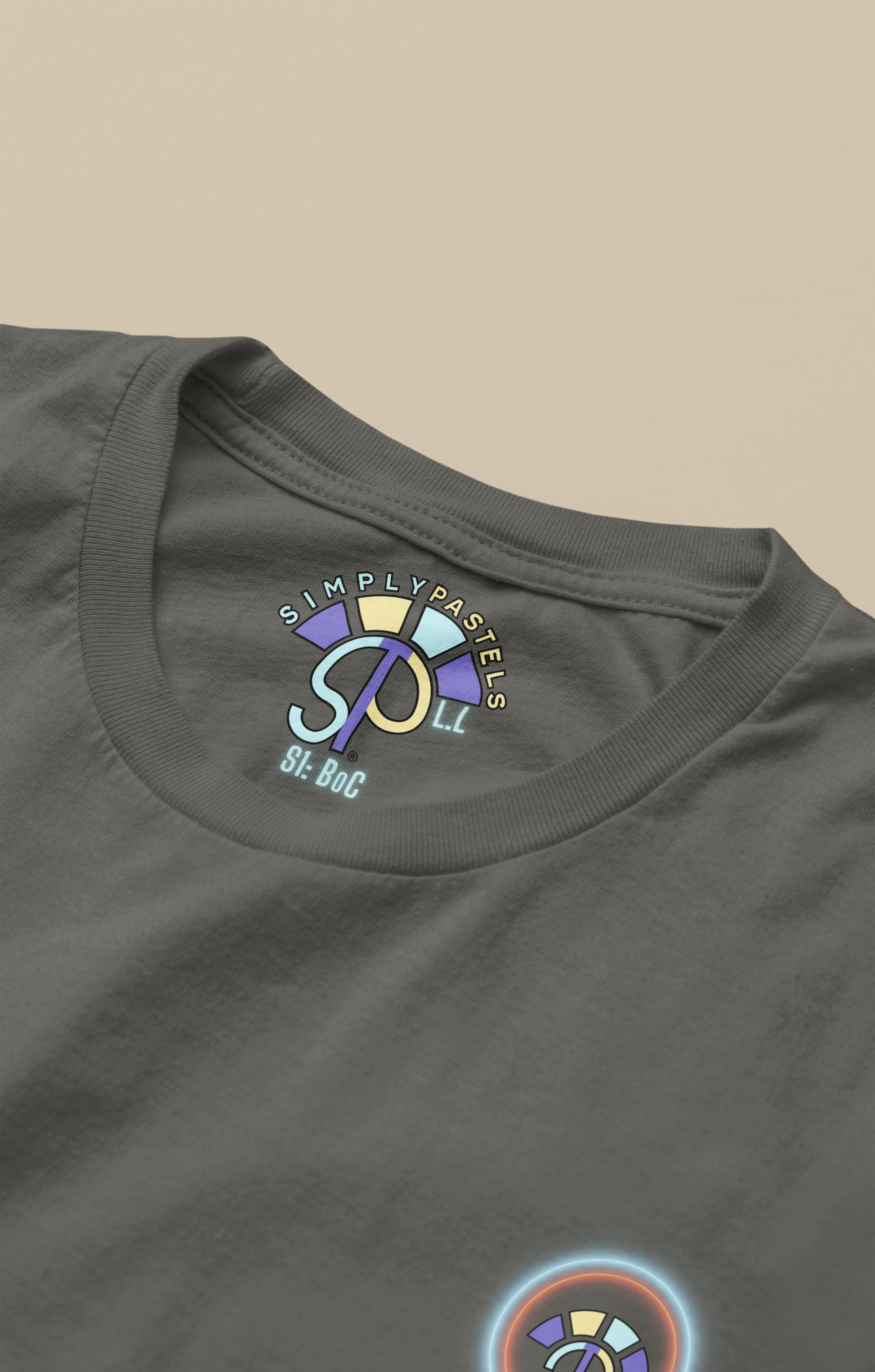 Label view of the khaki Limitless Levels organic cotton t-shirt with a pastel graphic design, from Simply Pastels, a UK-based premium ethical clothing brand.