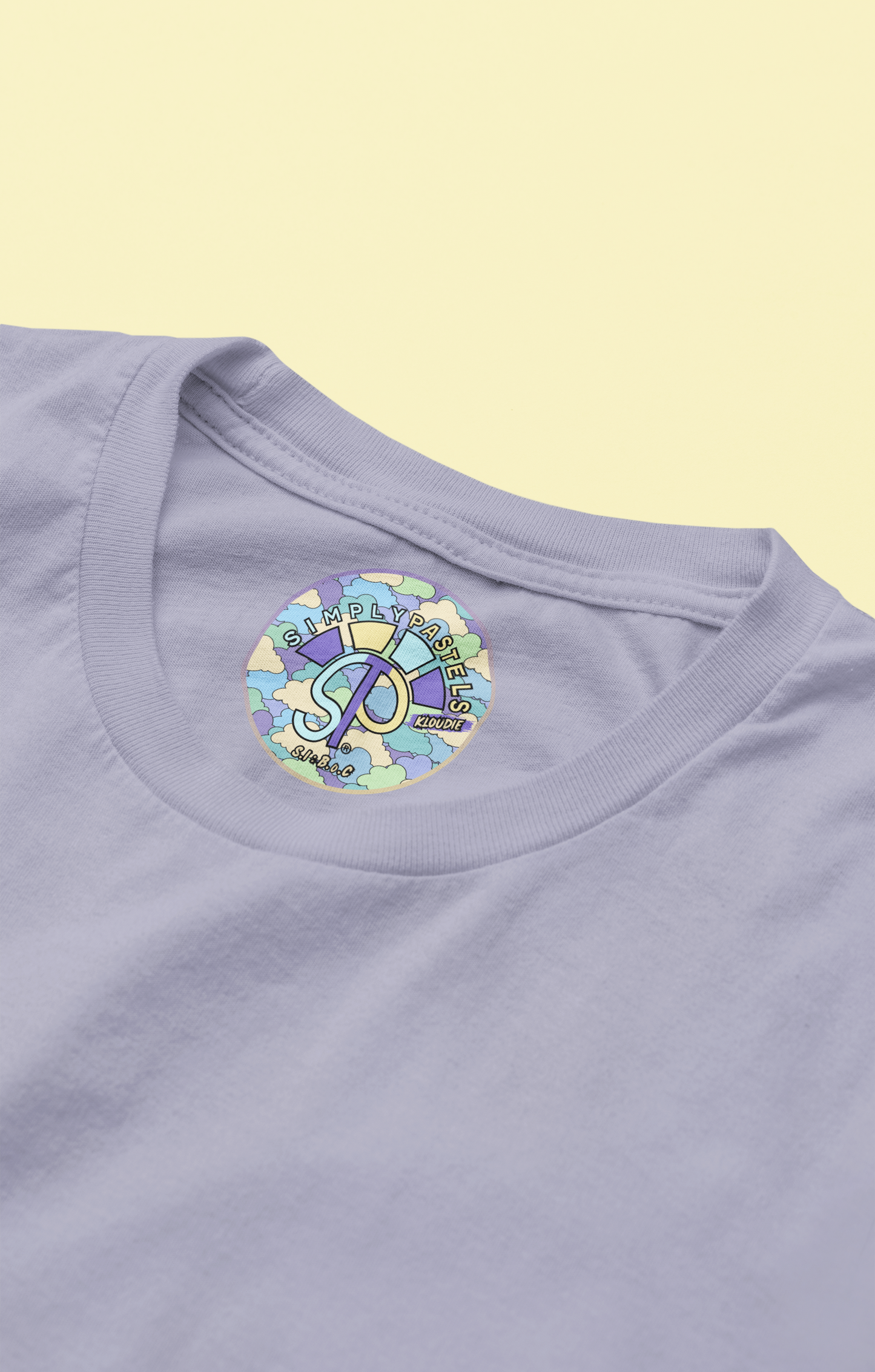 Label view of the lavender Kloudie organic cotton t-shirt with a pastel graphic design, from Simply Pastels, a UK-based premium ethical clothing brand.