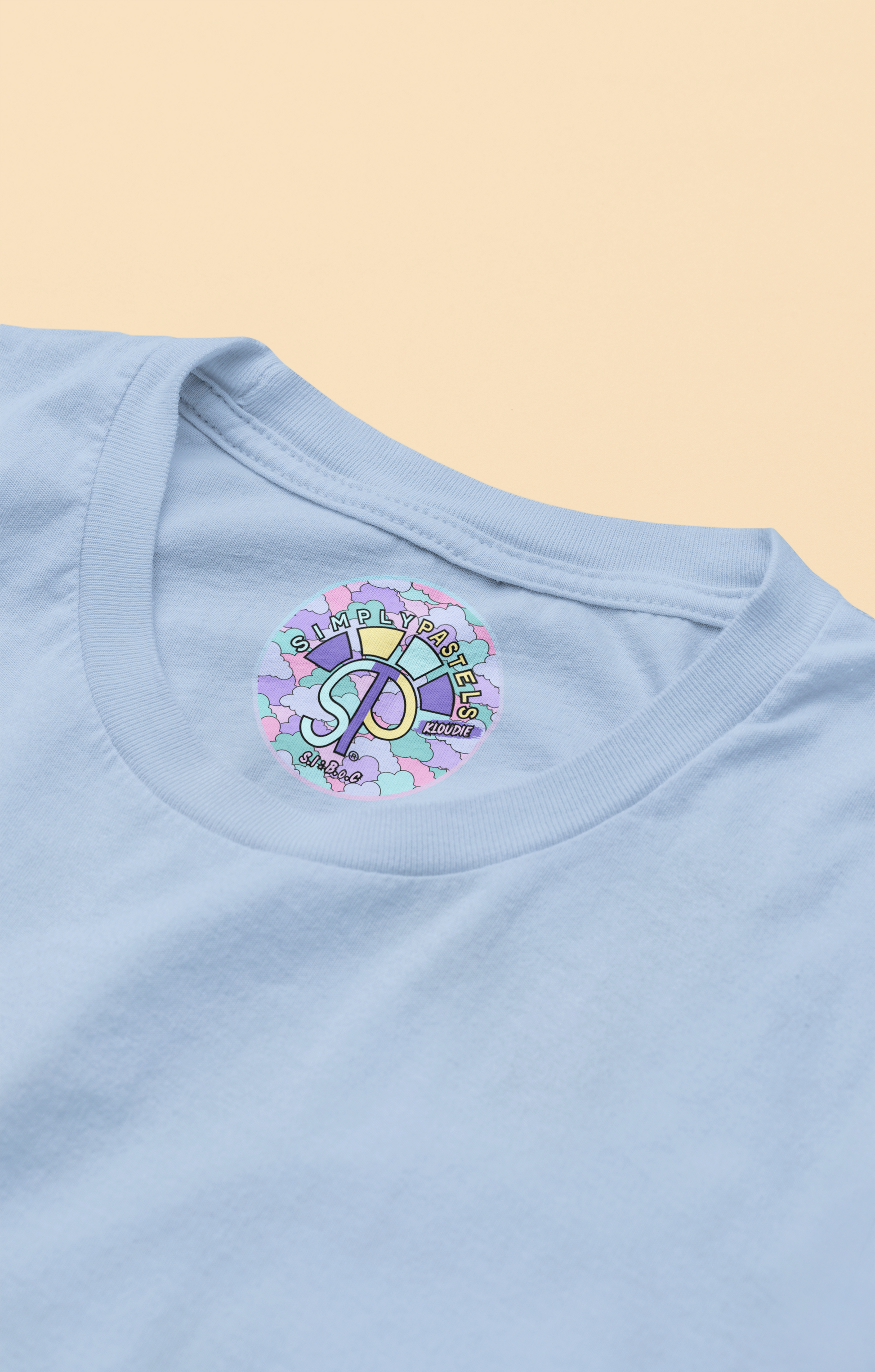 Label view of the blue soul Kloudie organic cotton t-shirt with a pastel graphic design, from Simply Pastels, a UK-based premium ethical clothing brand.
