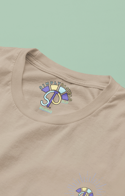 Label view of the desert dust Decisive Determination organic cotton t-shirt with a pastel graphic design, from Simply Pastels, a UK-based premium ethical clothing brand.