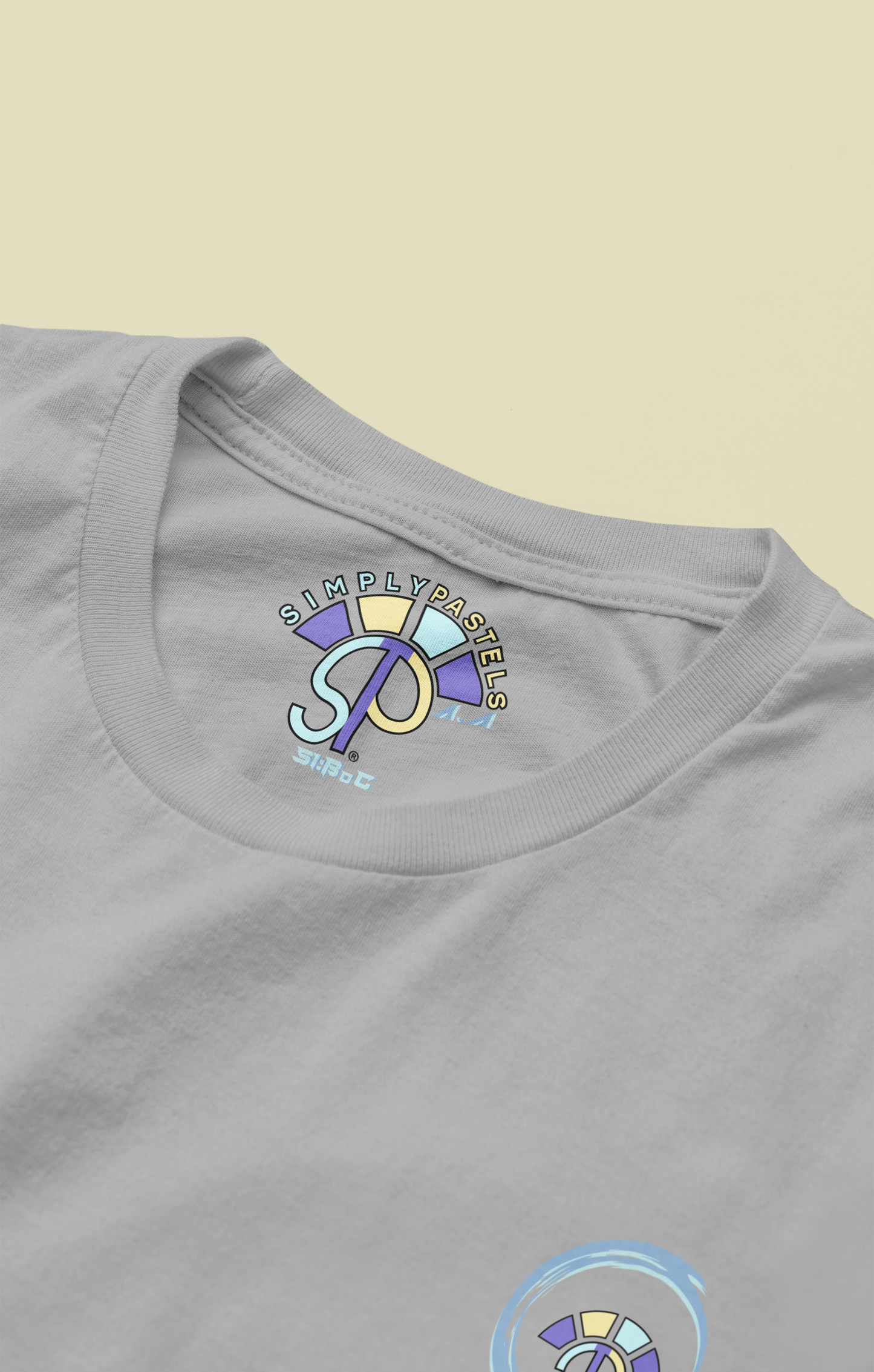 Label view of the heather grey Avid Aspiration organic cotton t-shirt with a pastel graphic design, from Simply Pastels, a UK-based premium ethical clothing brand.