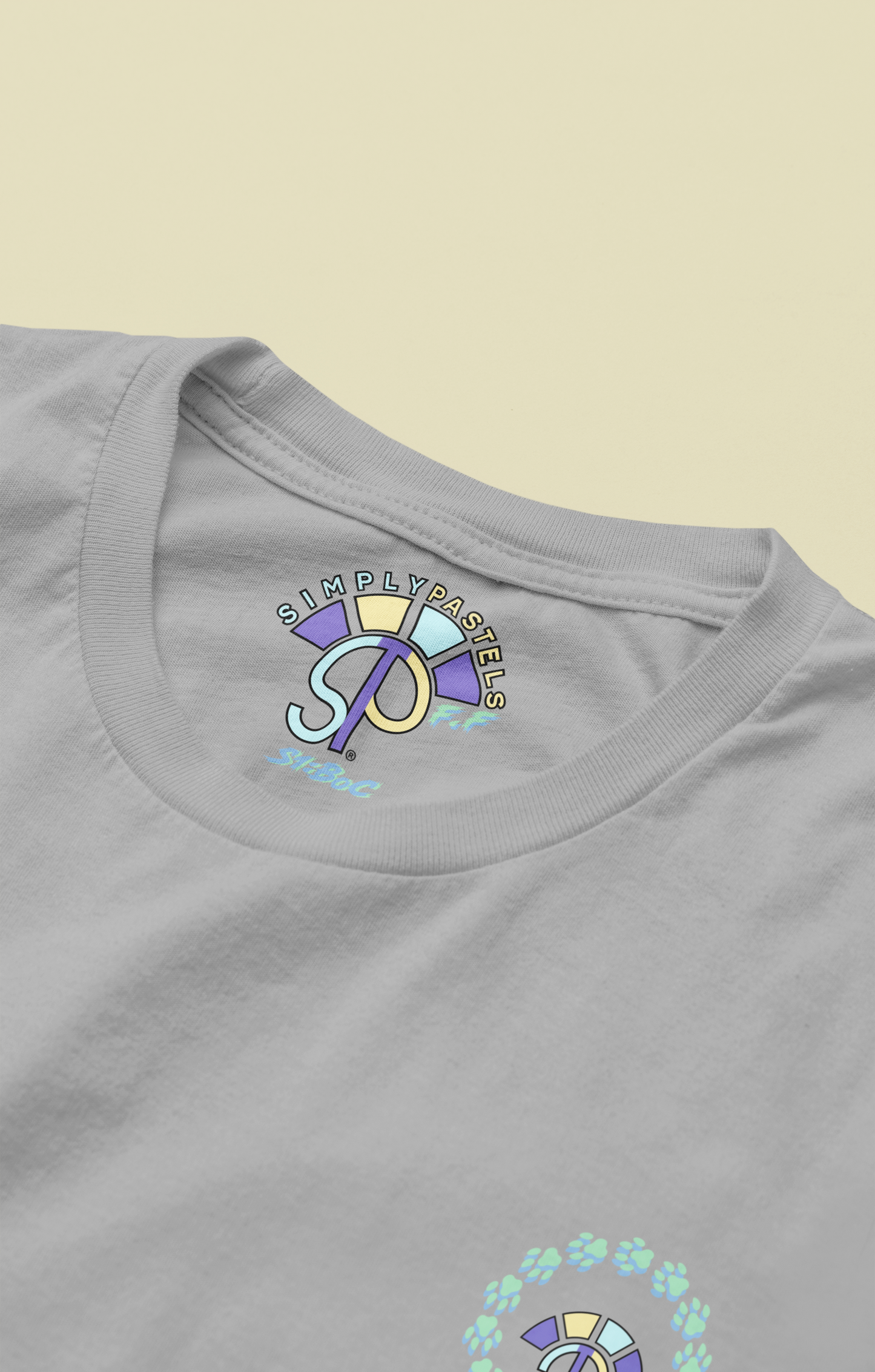 Label view of the heather grey Firm Fortitude organic cotton t-shirt with a pastel graphic design, from Simply Pastels, a UK-based premium ethical clothing brand.