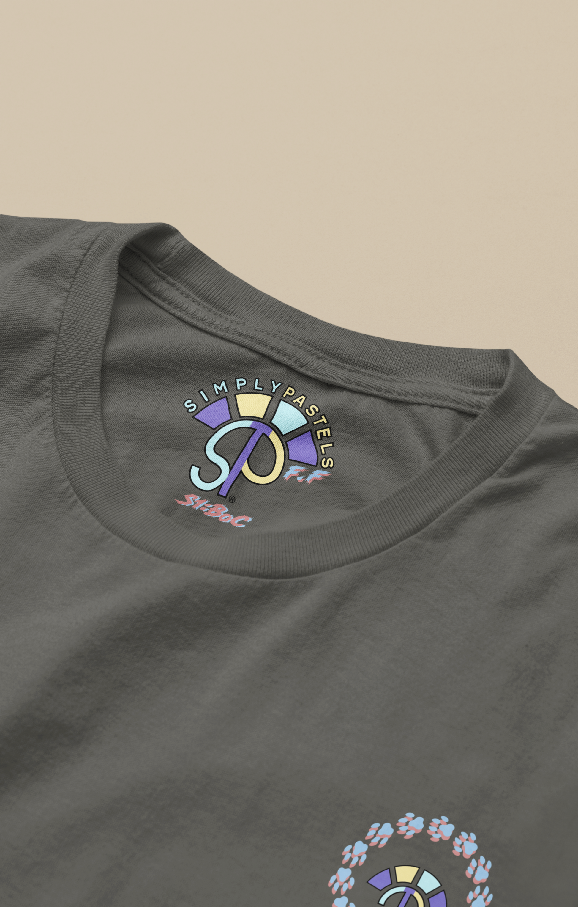 Label view of the khaki Firm Fortitude organic cotton t-shirt with a pastel graphic design, from Simply Pastels, a UK-based premium ethical clothing brand.