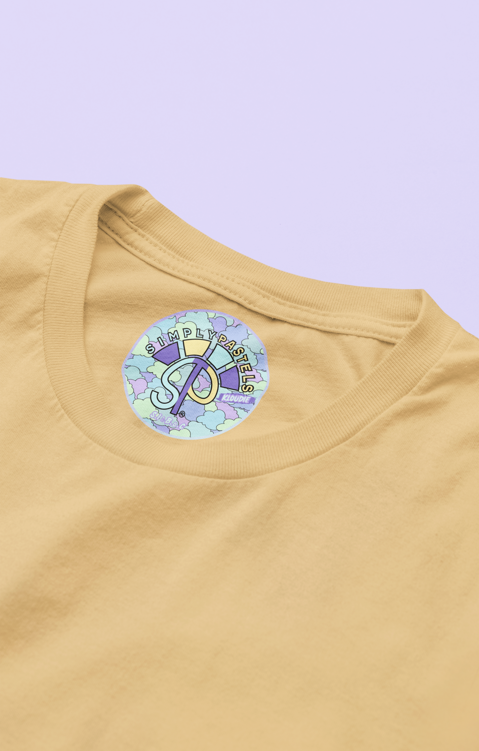 Label view of the nispero Kloudie organic cotton t-shirt with a pastel graphic design, from Simply Pastels, a UK-based premium ethical clothing brand.
