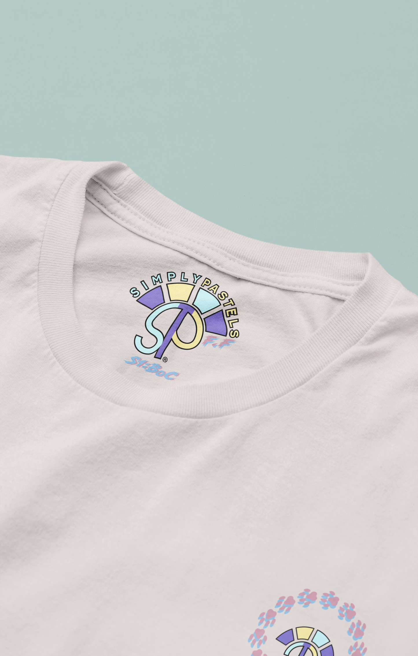 Label view of the off-white Firm Fortitude organic cotton t-shirt with a pastel graphic design, from Simply Pastels, a UK-based premium ethical clothing brand.