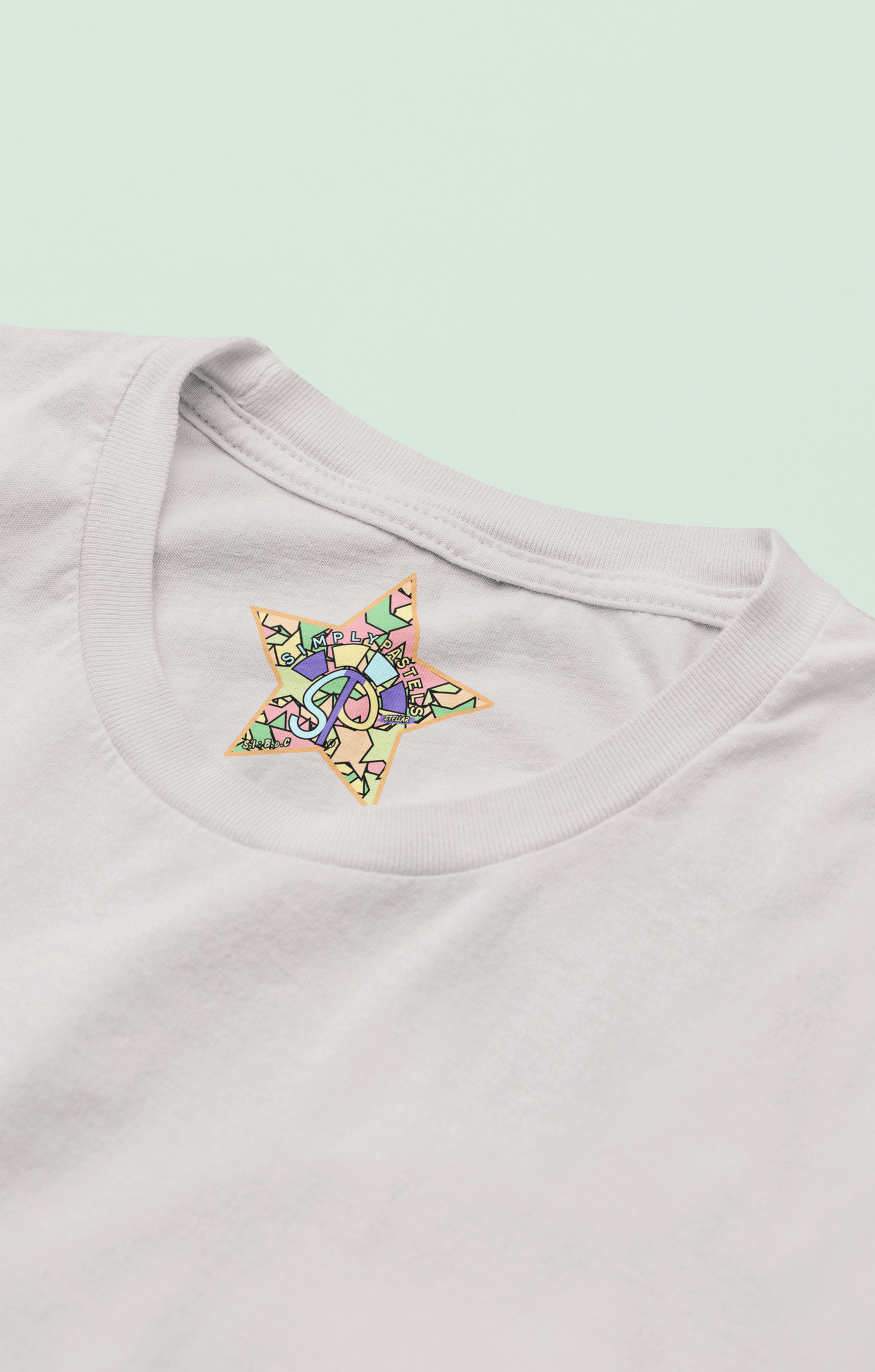 Label view of the off-white Stellar organic cotton t-shirt with a pastel graphic design, from Simply Pastels, a UK-based premium ethical clothing brand.
