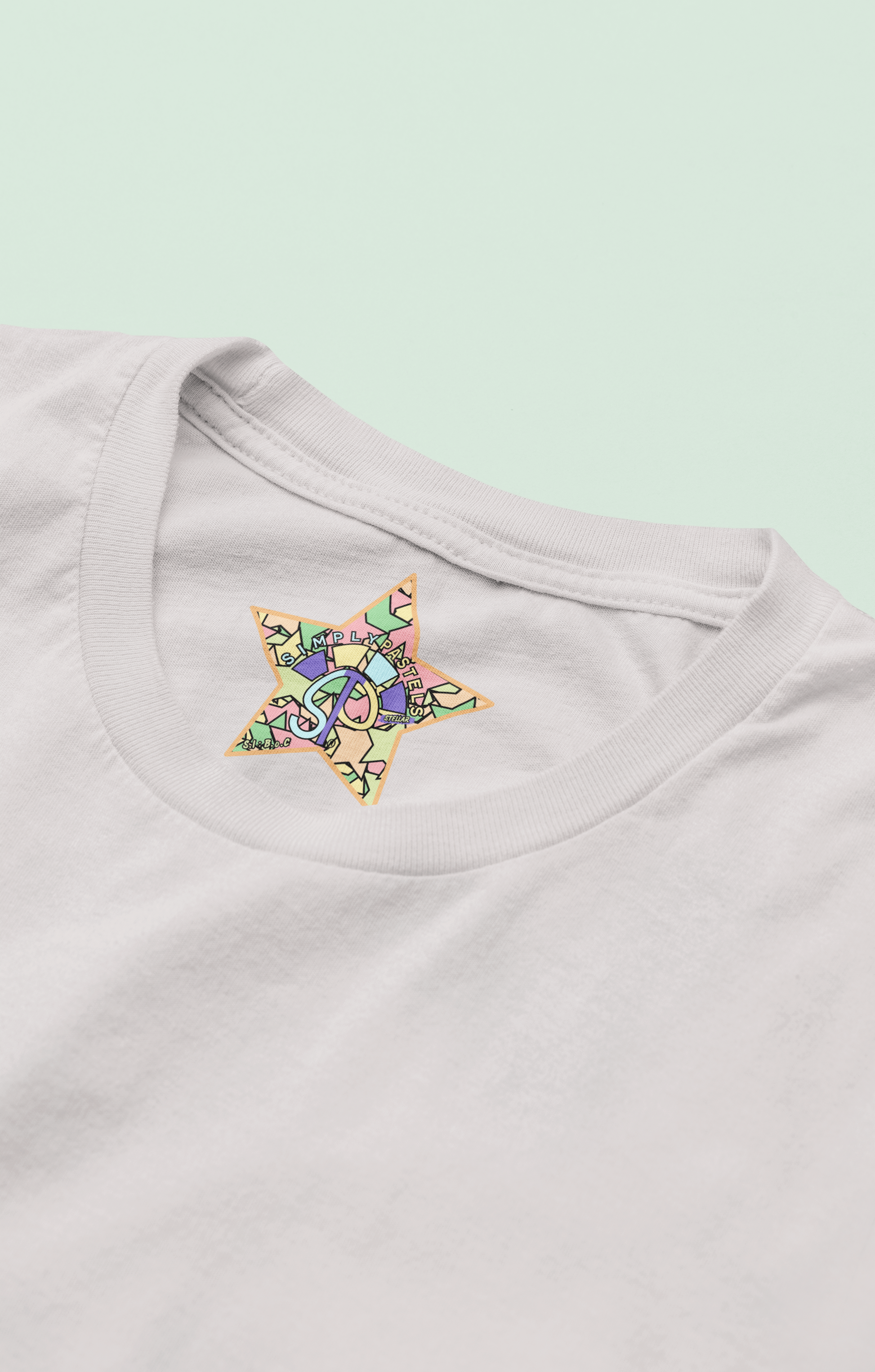 Label view of the off-white Stellar organic cotton t-shirt with a pastel graphic design, from Simply Pastels, a UK-based premium ethical clothing brand.
